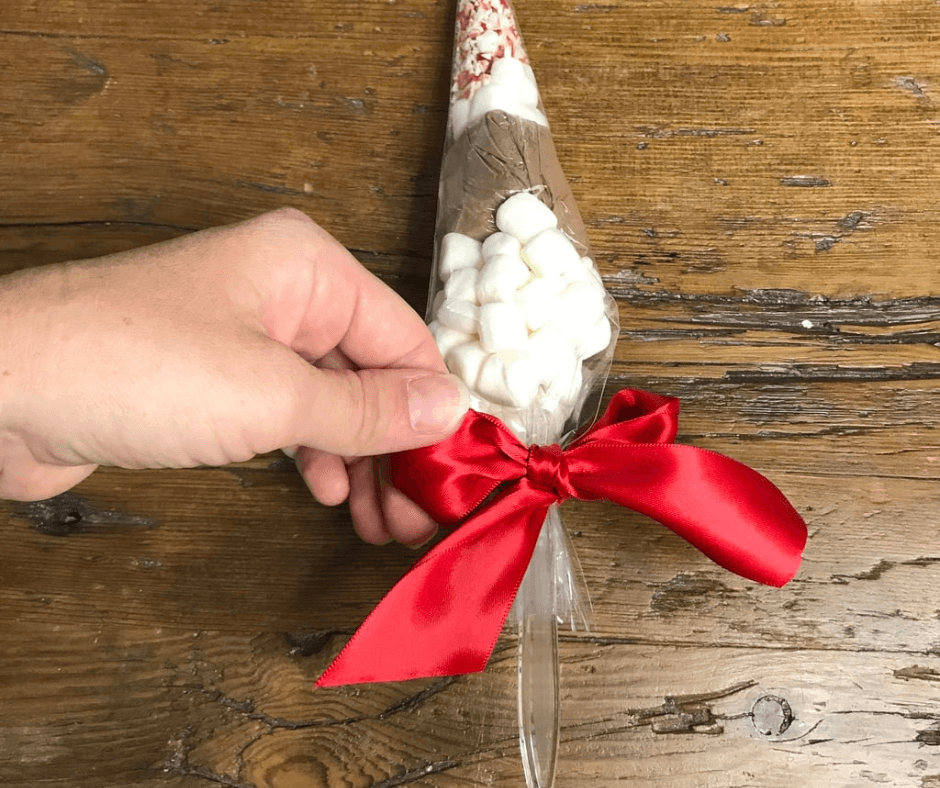 Placing a ribbon to the Hot Cocoa Bag