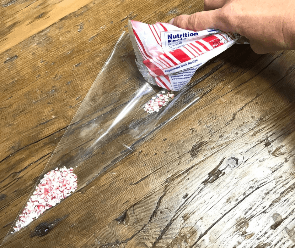 Pouring the crushed peppermint into the clear cellophane