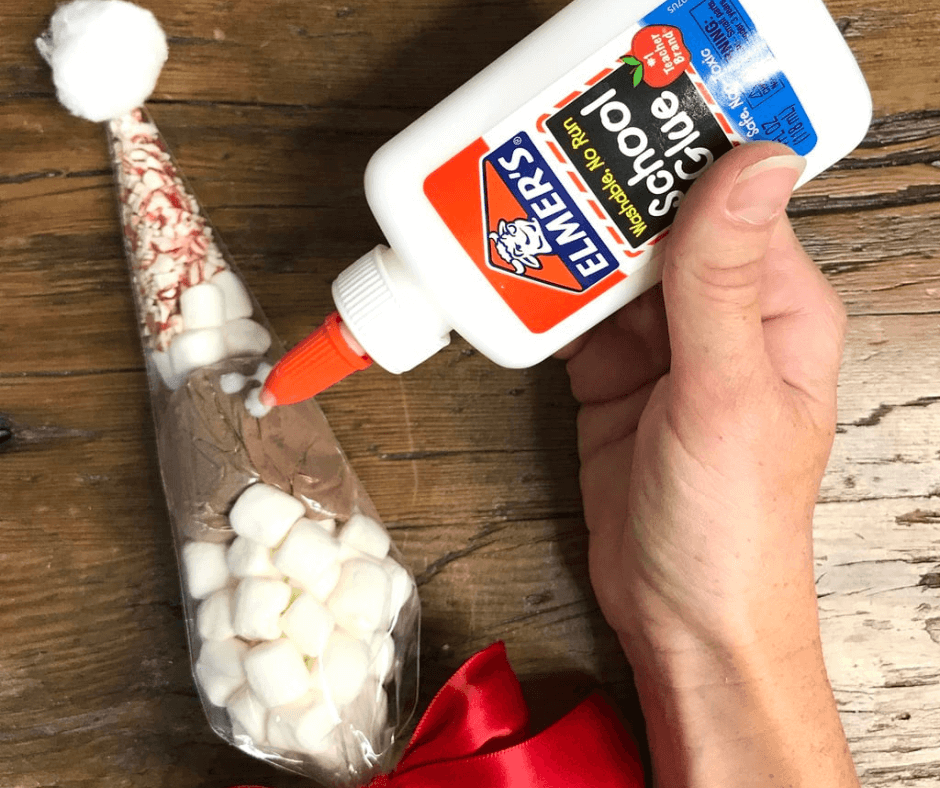 Putting glue into the Individual Santa Hot Cocoa Bag
