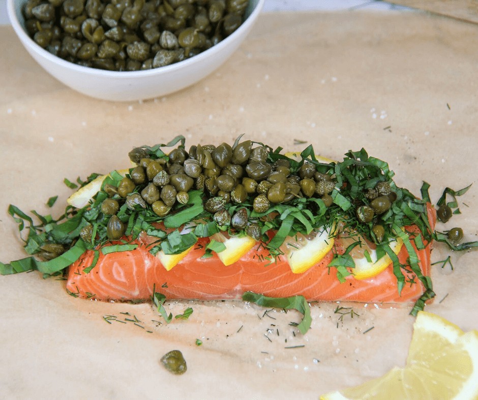 Seasoned salmon topped with lemon, herbs and capers