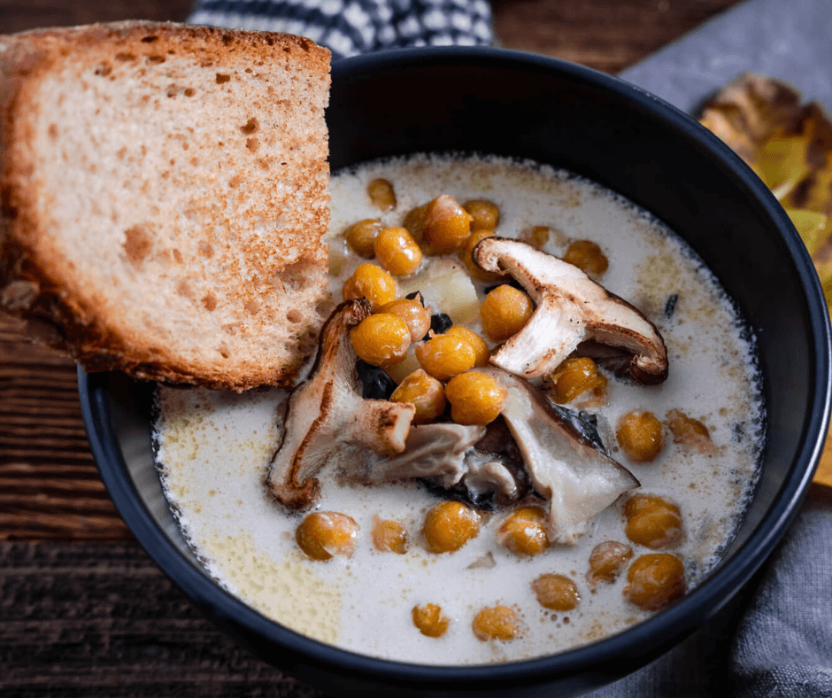 A bowl of Best Creamy Vegetable Winter Soup with sliced bread