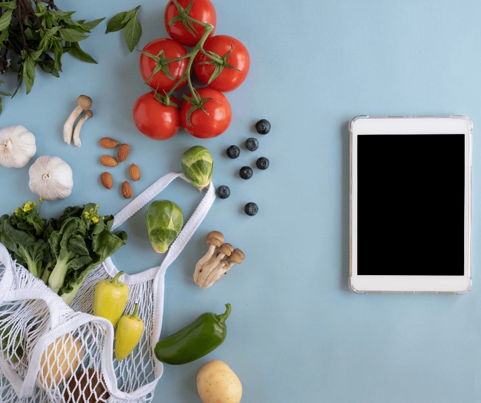 photo of produce, a white mesh bag and a blank computer tablet 