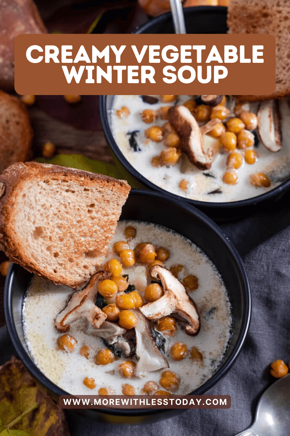 Two bowls of Best Creamy Vegetable Winter Soup with sliced bread on black bowls - PIN