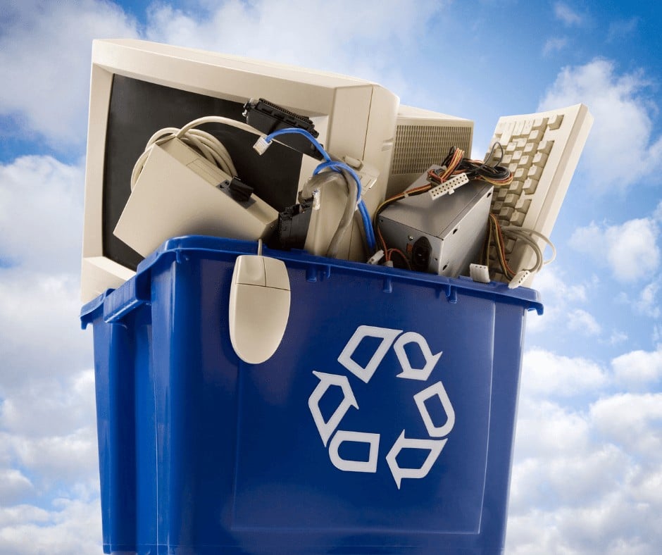 A blue recycle pin full of old electronics