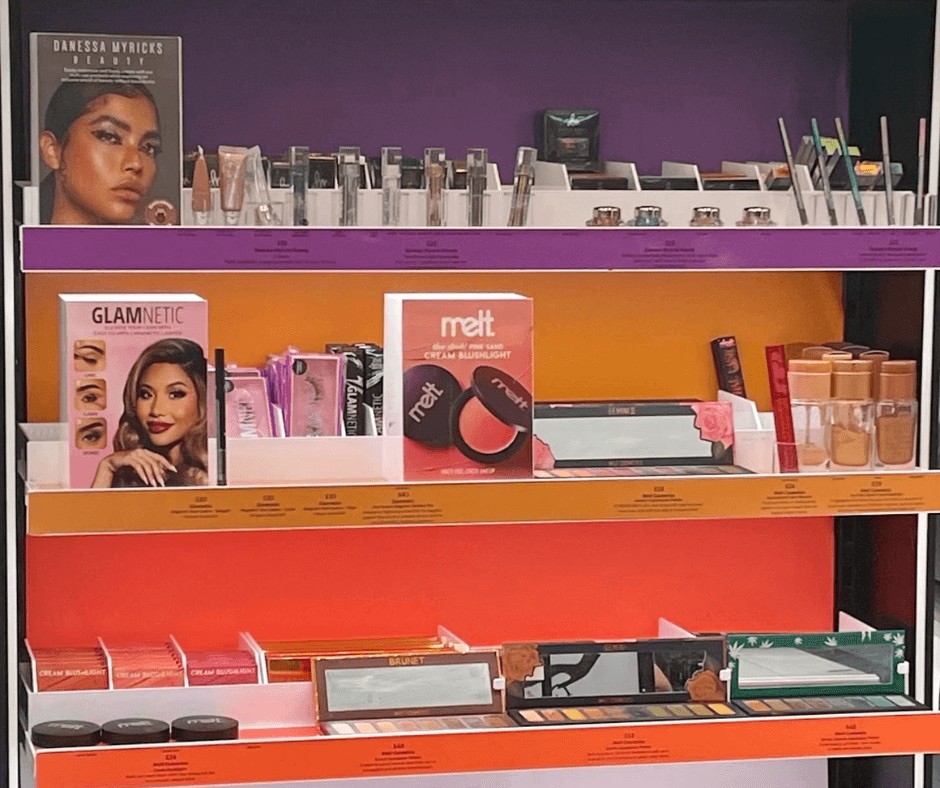 Colorful makeup products on a 3 shelf display