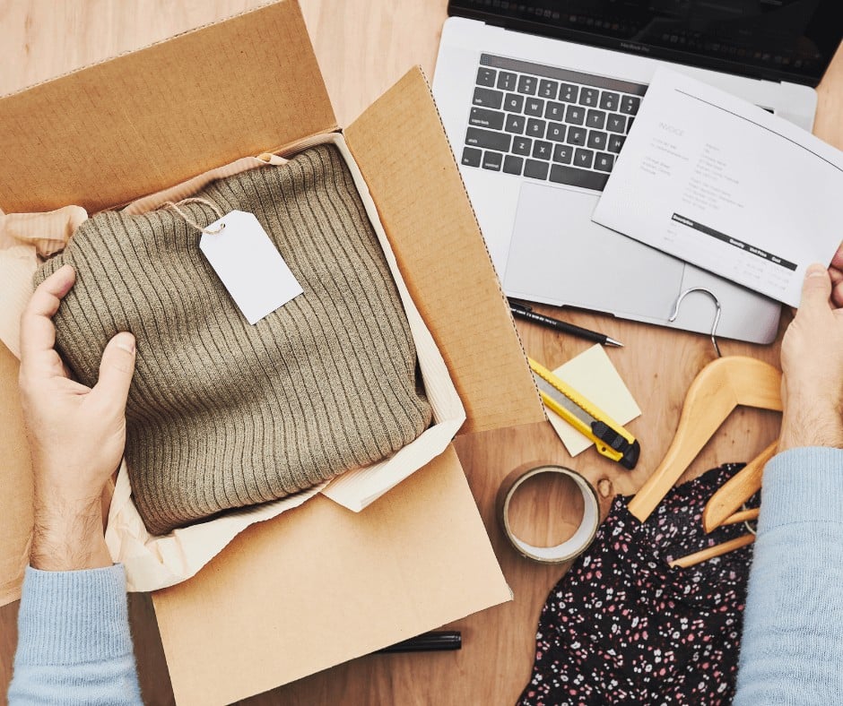 Woman packing an order in a box alongside the tracking information