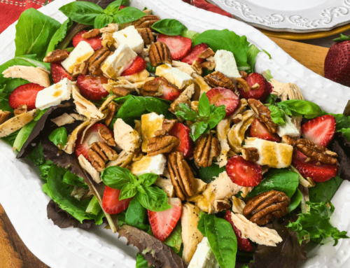 A serving of Strawberry Chicken Salad with Pecans and Feta on white plate