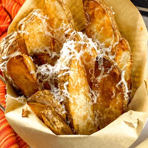 Air Fryer Truffle Potato Wedges with Parmesan served in a clean parchment paper