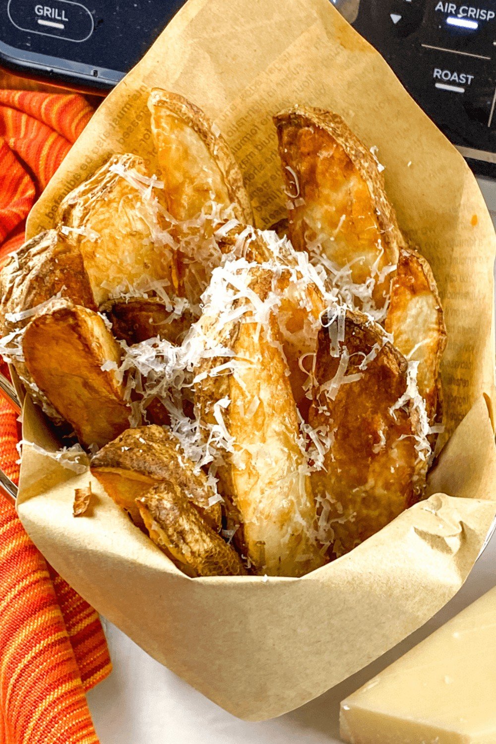 Air Fryer Truffle Potato Wedges with Parmesan served in a clean parchment paper