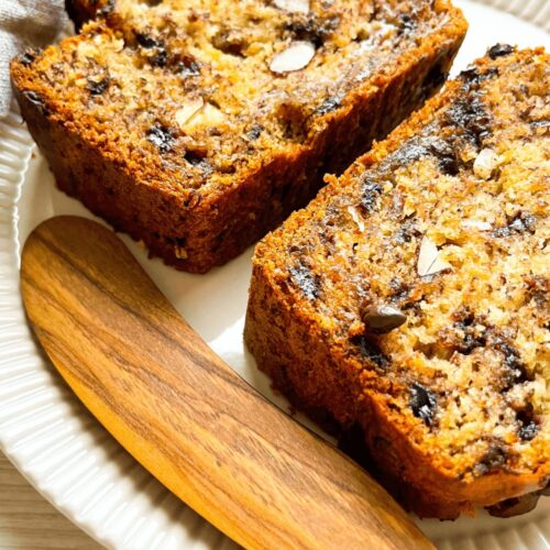 A closeup of two slices of Almond Chocolate Chip Banana Bread