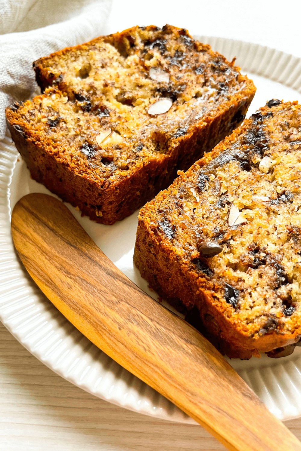 A closeup of two slices of Almond Chocolate Chip Banana Bread