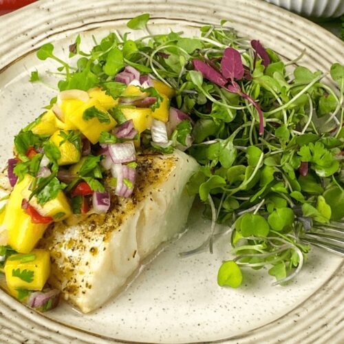 A serving of Air Fryer Mahi Mahi with Spicy Mango Salsa and Microgreens