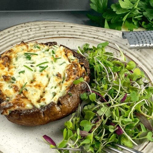 A serving of Best and Easy Stuffed Portobello Mushroom on a white plate