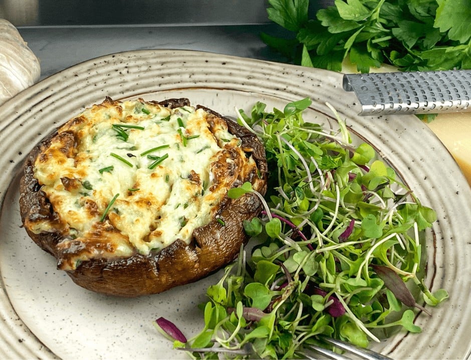 A serving of Best and Easy Stuffed Portobello Mushroom on a white plate