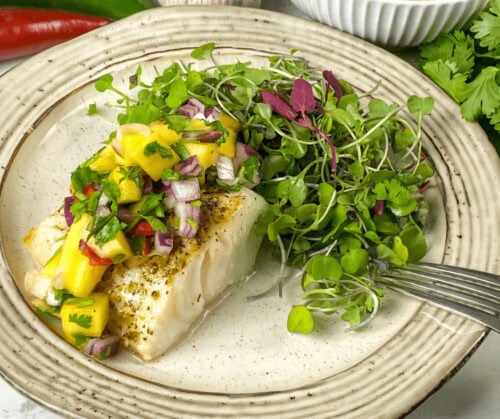 Air Fryer Mahi Mahi with Spicy Mango Salsa served on a white plate