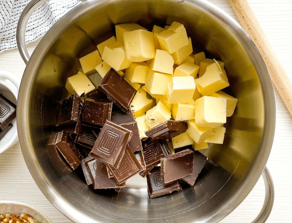 Butter and dark chocolate slices in a medium saucepan