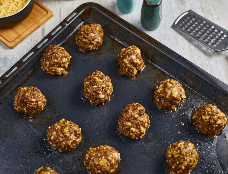 Cooked Italian meatballs on a baking pan