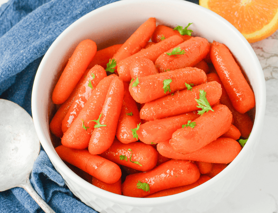 Four-Step Orange Glazed Carrots served on a white bowl