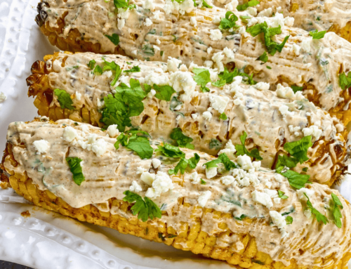 Mexican Street Corn (Elotes) served on a white plate