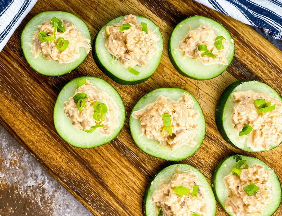 Spicy Tuna Cucumber Bites served on a wooden platter