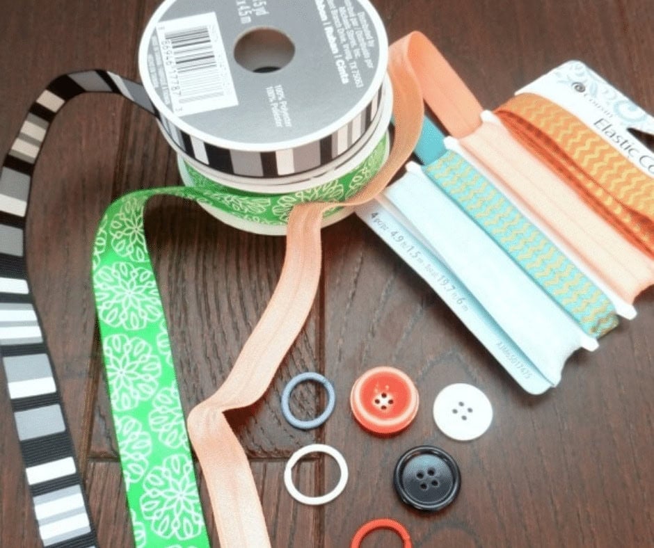 Supplies used for DIY Bookmarks including elastic and buttons