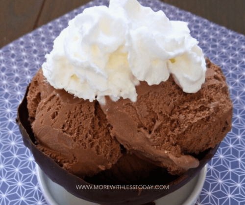 Three scoops of ice cream topped with whipped cream and placed on an Edible Chocolate Dessert Bowls