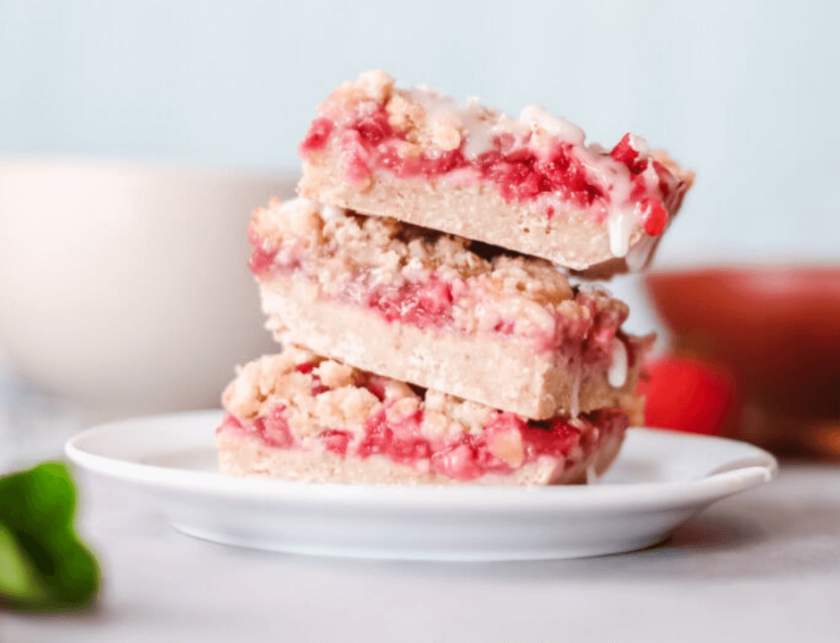 Three slices of Strawberry Banana Breakfast Bars served on a white plate