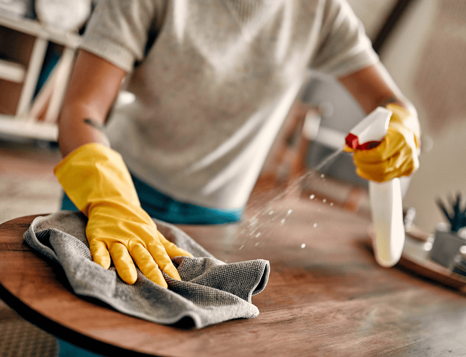 A person using water and salt to clean furniture