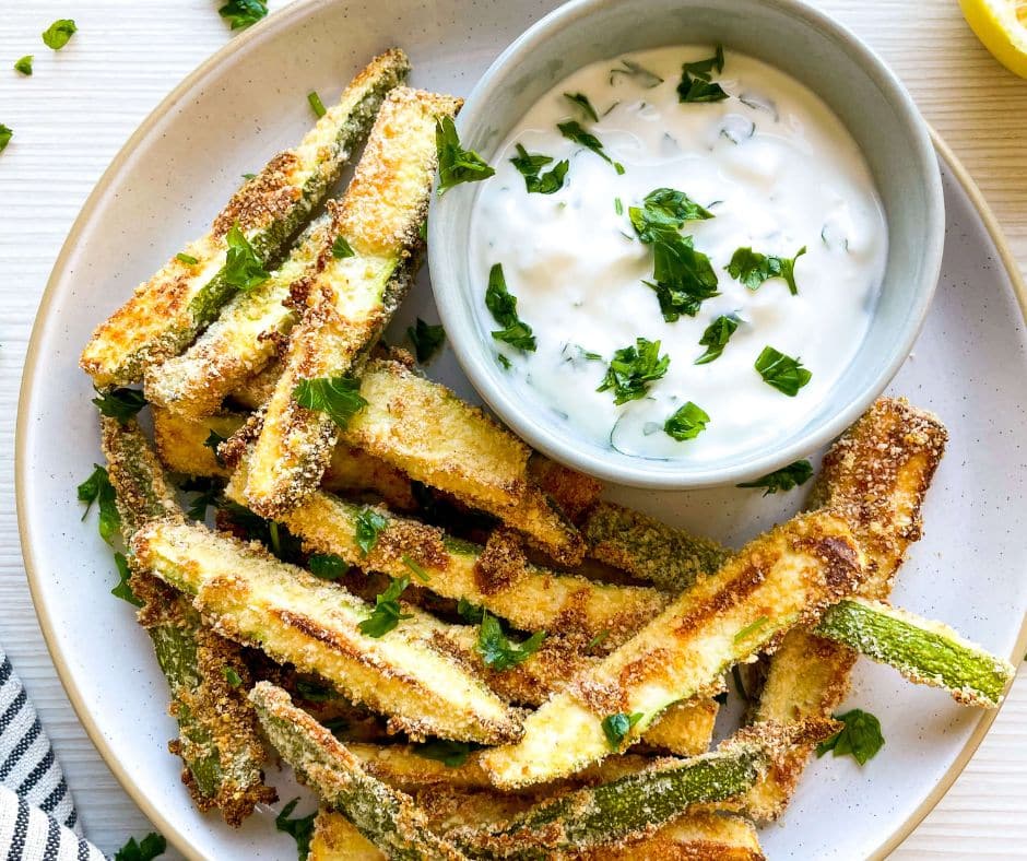 Baked Zucchini Fries with Greek Yogurt Dip served on a white plate