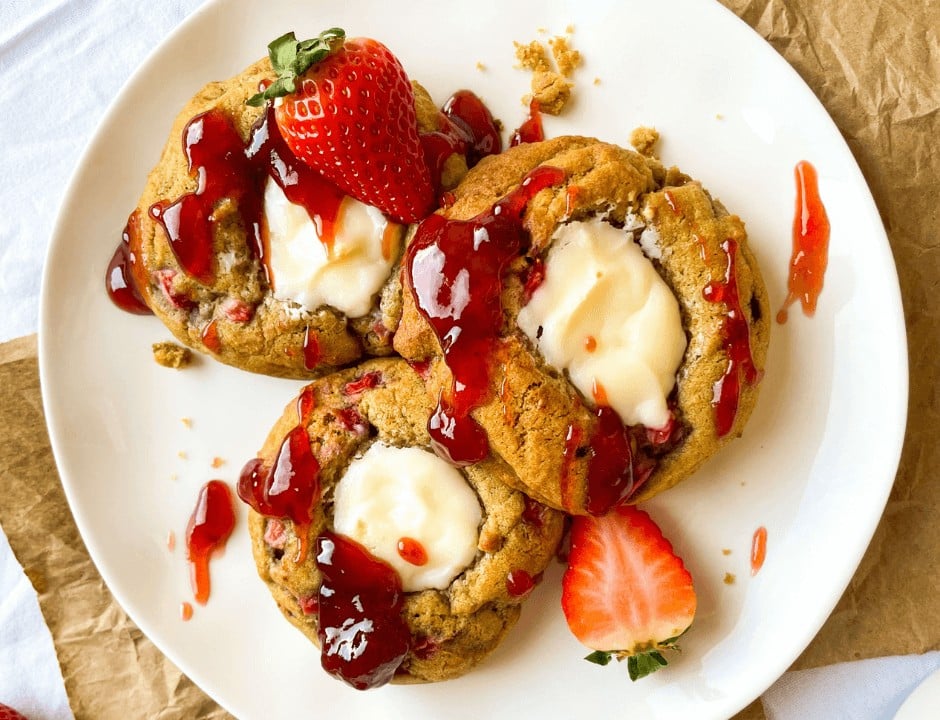 Strawberry Cheesecake Cookies with strawberry jam drizzled on top