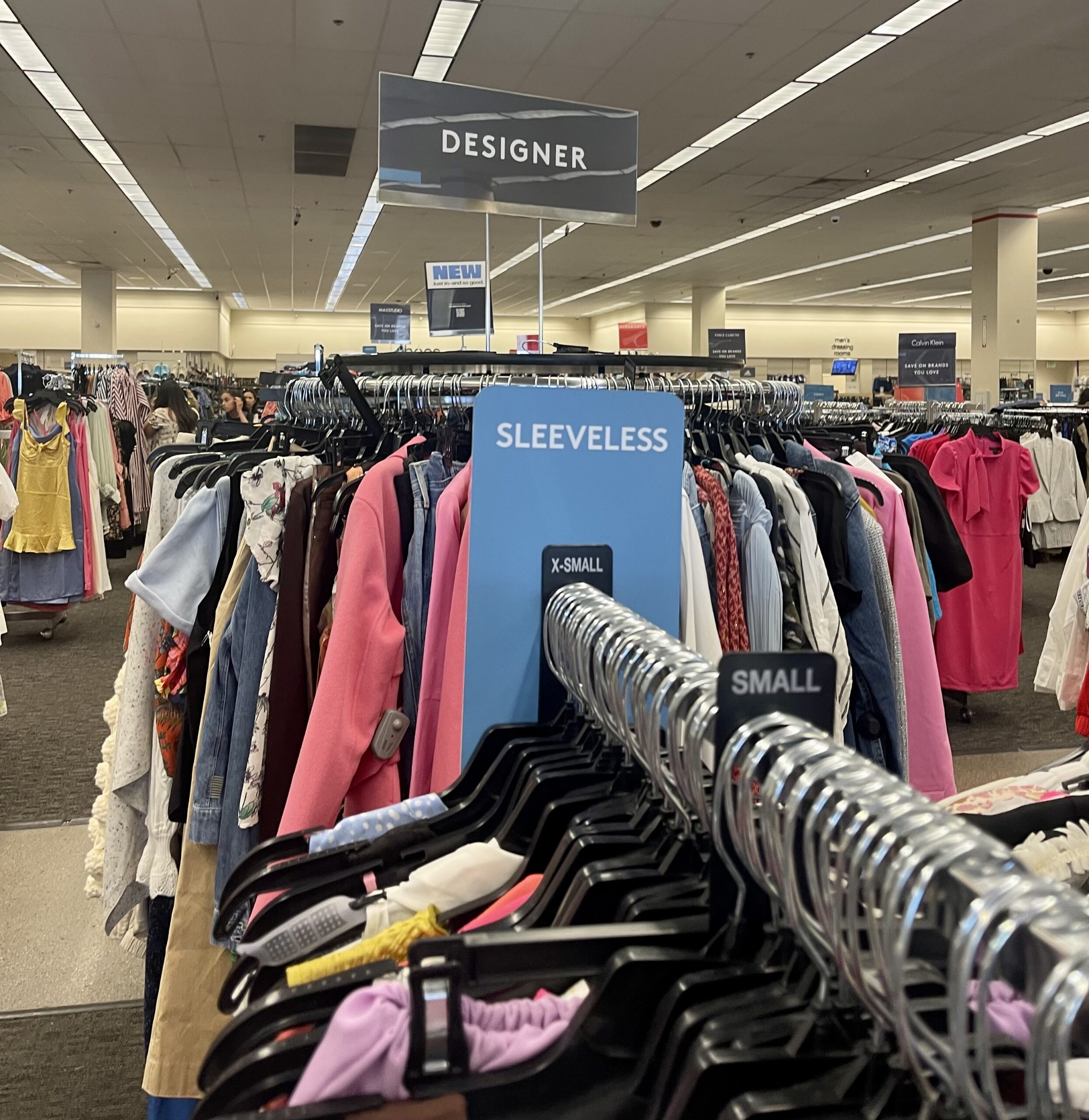 Men's clothing is displayed for sale inside a Nordstrom Rack store