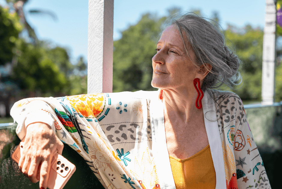 A woman sitting outside - Travel Clothes for Women Over 50