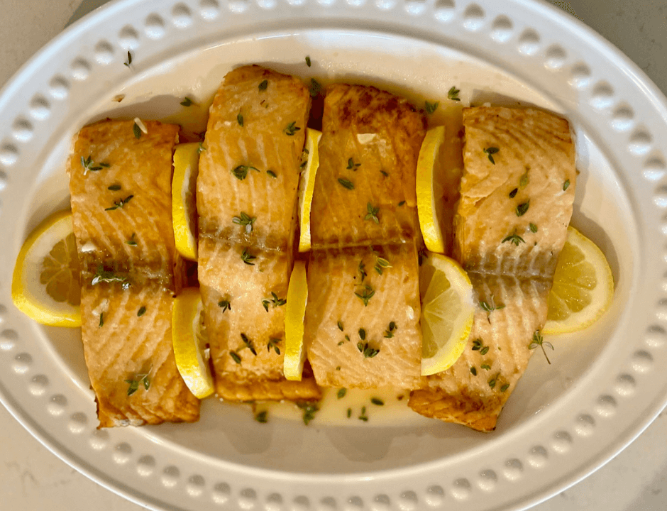 Slices of Lemon Butter Garlic Salmon served on a white plate