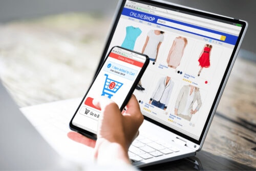 A closeup of a hand and an opened laptop for Shop Clearance Sales Online post