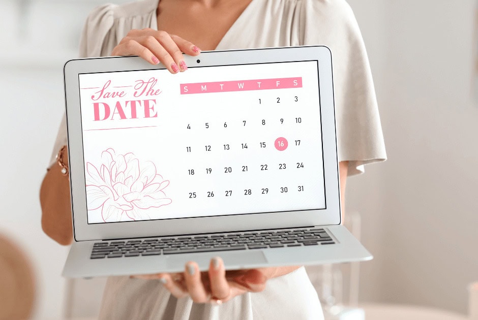 Closeup of a laptop with a save the date calendar