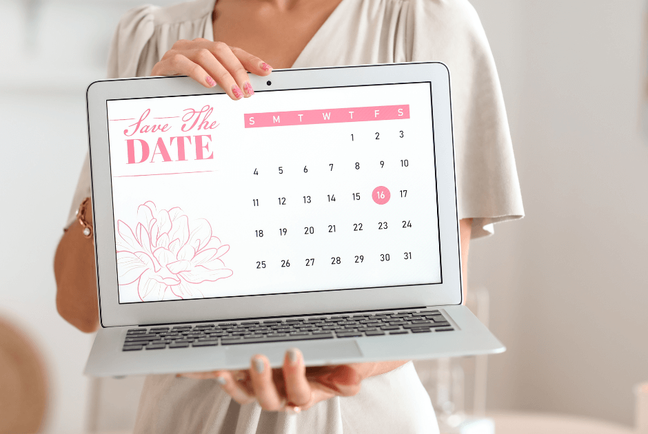 Closeup of a laptop with a save the date calendar