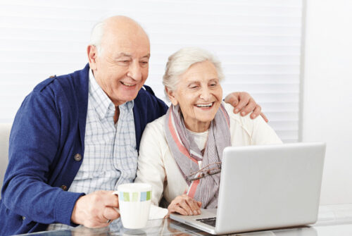 A senior couple looking at a laptop screen