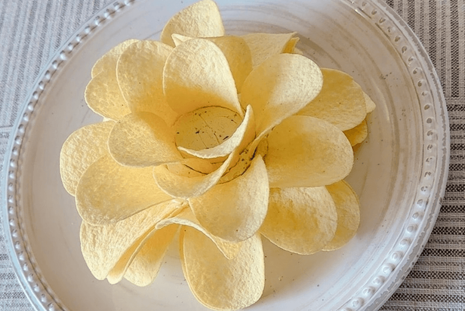 A closeup of Boursin Potato Chip Flower Appetizer served on a white plate