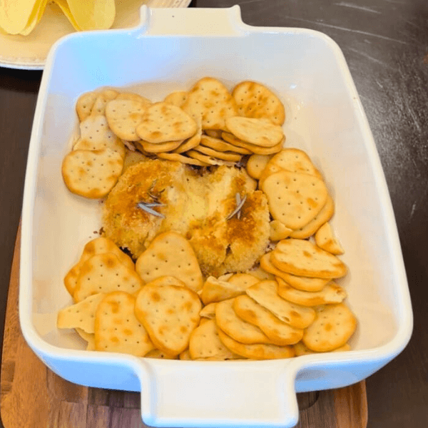 Crackers and baked Boursin cheese in a serving dish