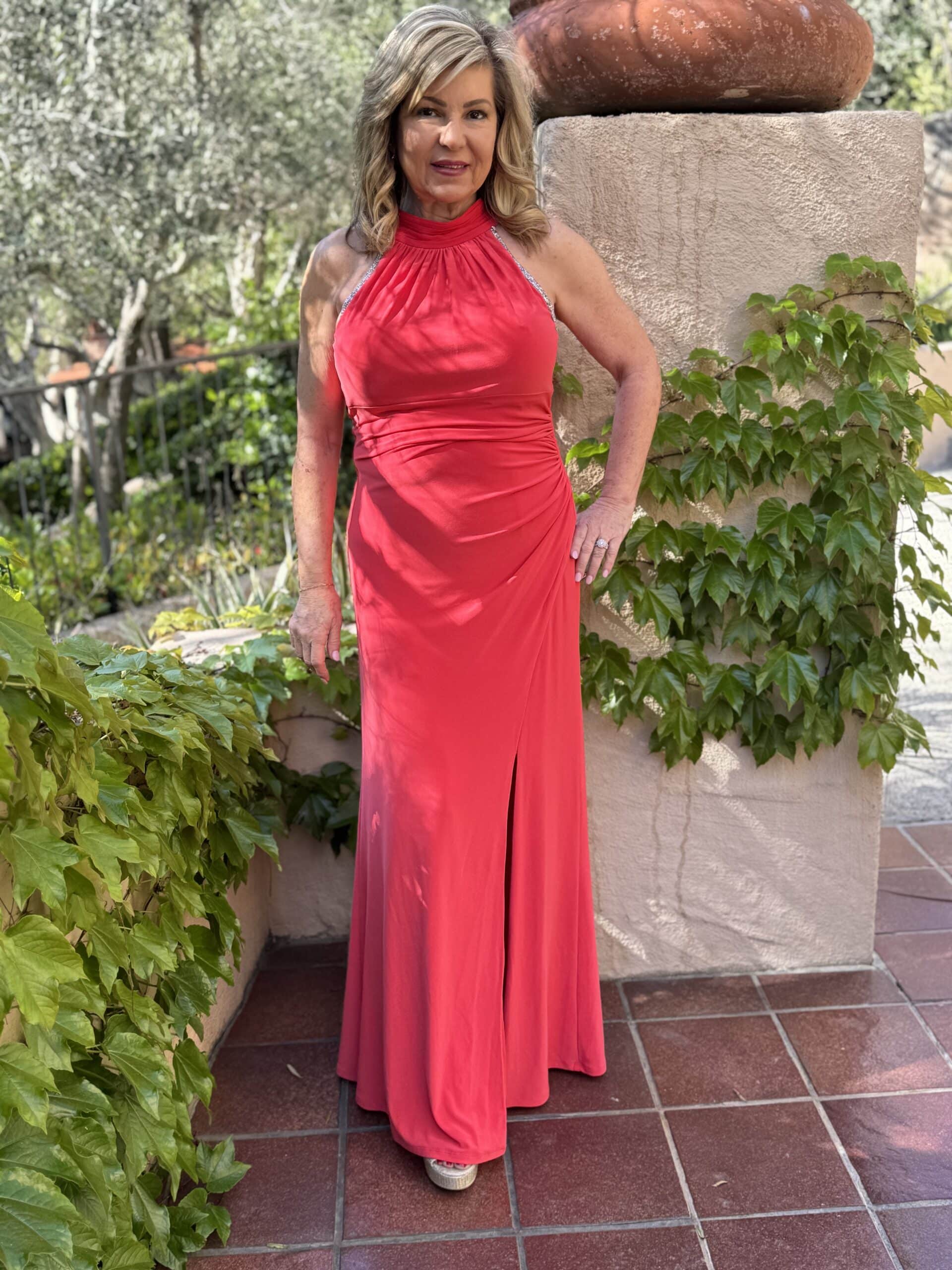 Lori Felix wearing a red long dress from Curated Brands