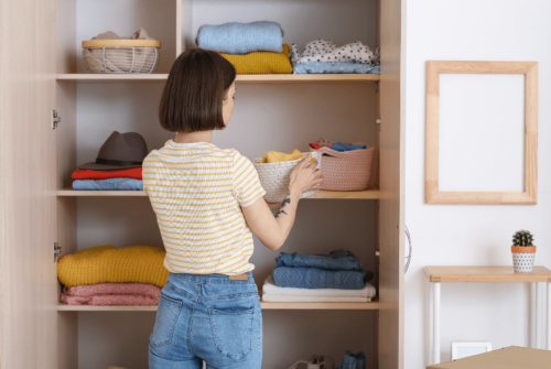 A woman organizing her closet - Transform Your Home with The Home Edit