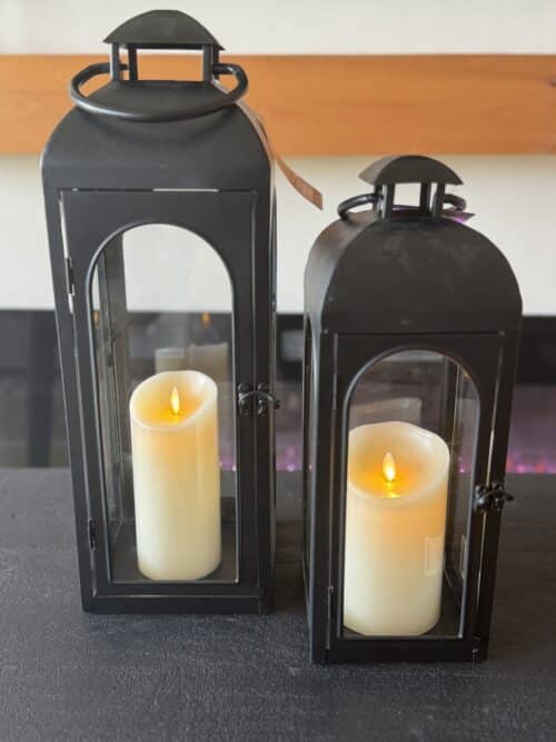 two black decorative lanterns from Walmart with battery-operated candles