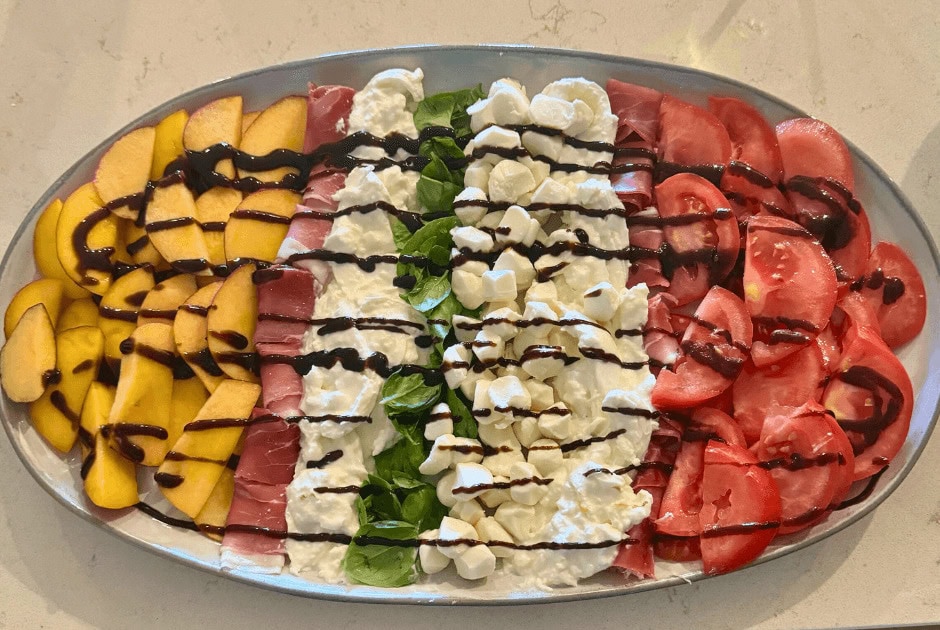 A large platter of Peach and Heirloom Tomato Caprese Appetizer