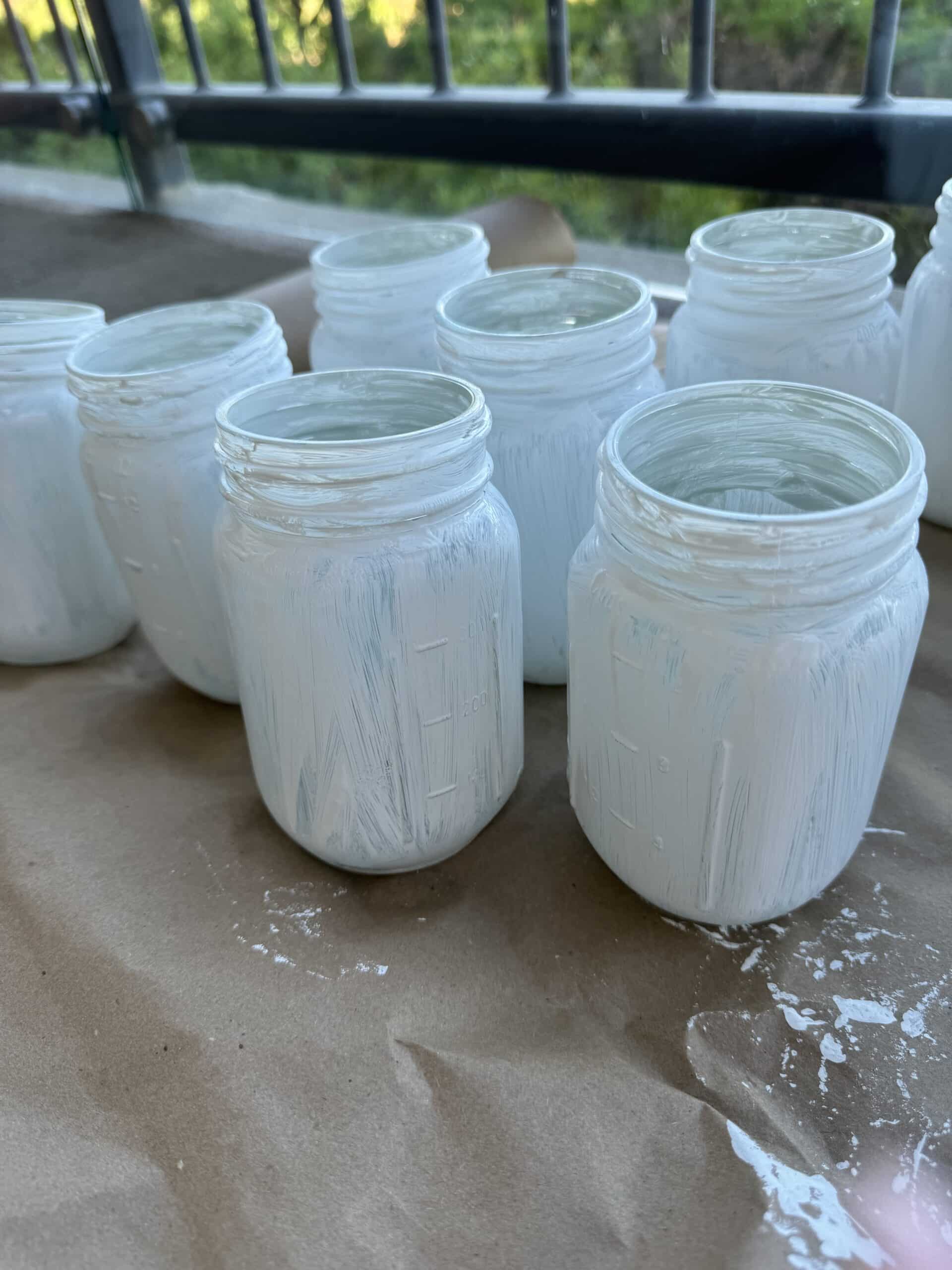 paiting canning jars with white acrylic paint for 4th of July centerpieces