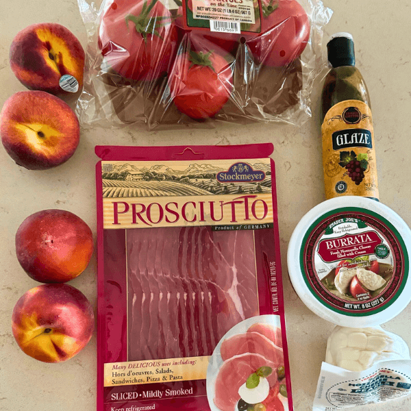 Ingredients for Peach and Tomato Caprese Appetizer from Trader Joe's including peaches, Burrata Cheese, Prosciutto, Balsamic Glaze and Heirloom Tomatoes