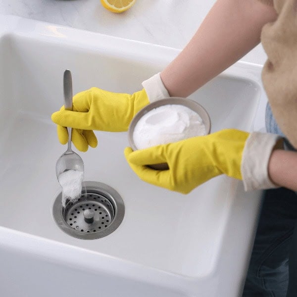 Unclogging a sink drain using baking soda