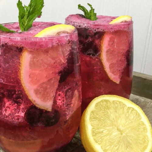 A closeup of two glasses of Blueberry Maple Lemonade