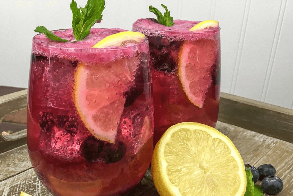 A closeup of two glasses of Blueberry Maple Lemonade