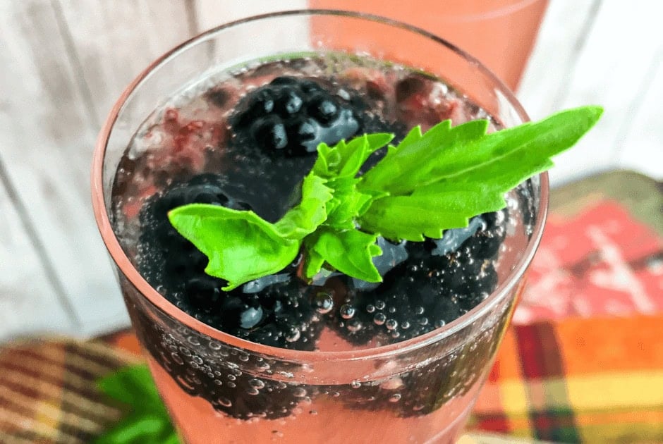 a closeup of a glass of Blackberry Basil Prosecco Cocktail