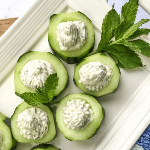 A closeup of Whipped Feta Cucumber Cups on a serving dish